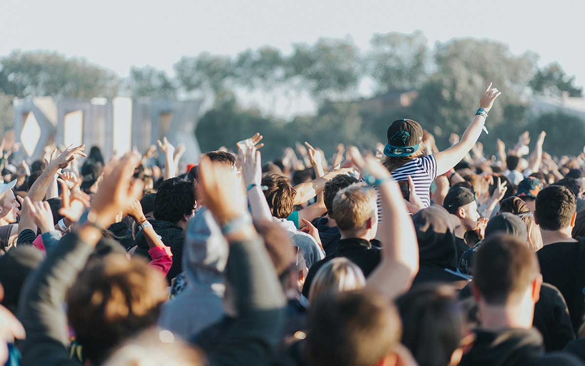 Crowd wearing custom printed event wristbands printed with event and sponsor branding