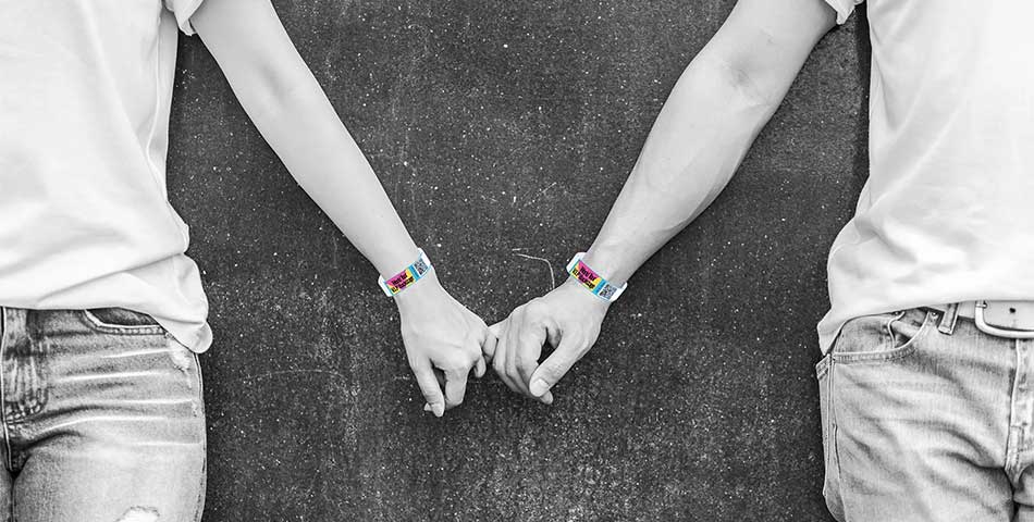 Patrons at Canadian event wearing waterproof custom printed paper wristbands with sponsor branding and QR code
