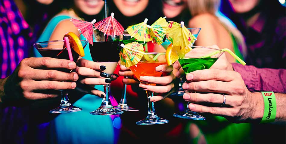 Group of friends wearing drinking age ID wristbands at nightclub in BC, Canada