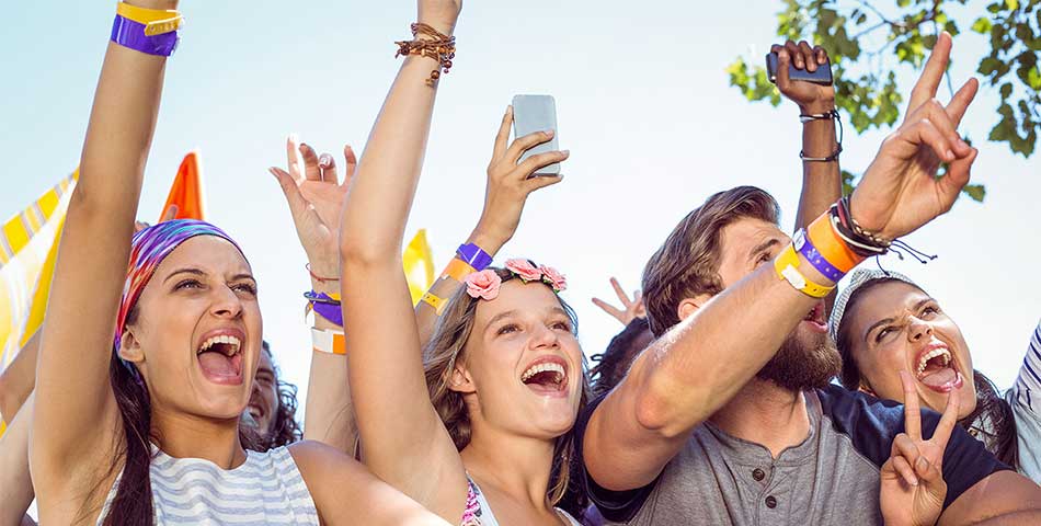 Concert-goers wearing durable vinyl wide face wristbands for multiday access to music concert in Canada